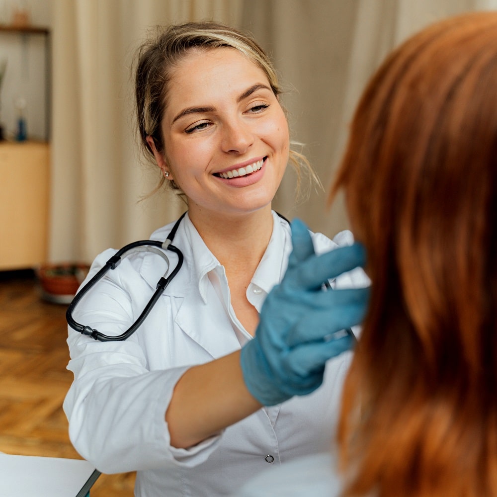 A happy doctor examining a patient.
