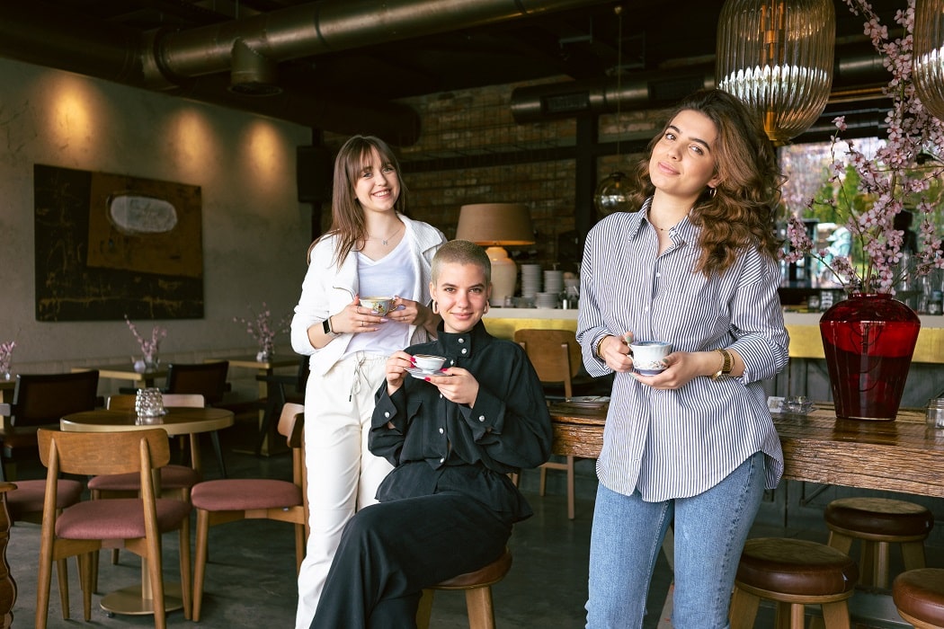 Happy restaurant employees enjoying coffee